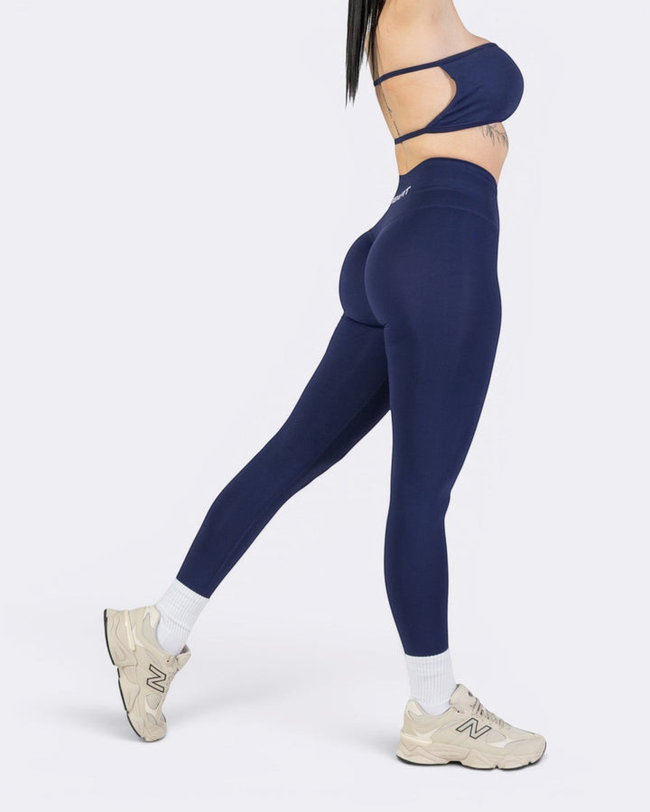 Modella indossa leggings Bombafit Oasis blu notte a vita alta con effetto push-up modellante per allenamento